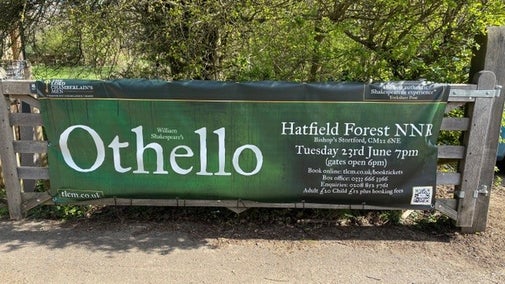 Poster on wooden gate at entrance to lakeside area, for the Lord Chamberlains production of Othello at Hatfield Forest